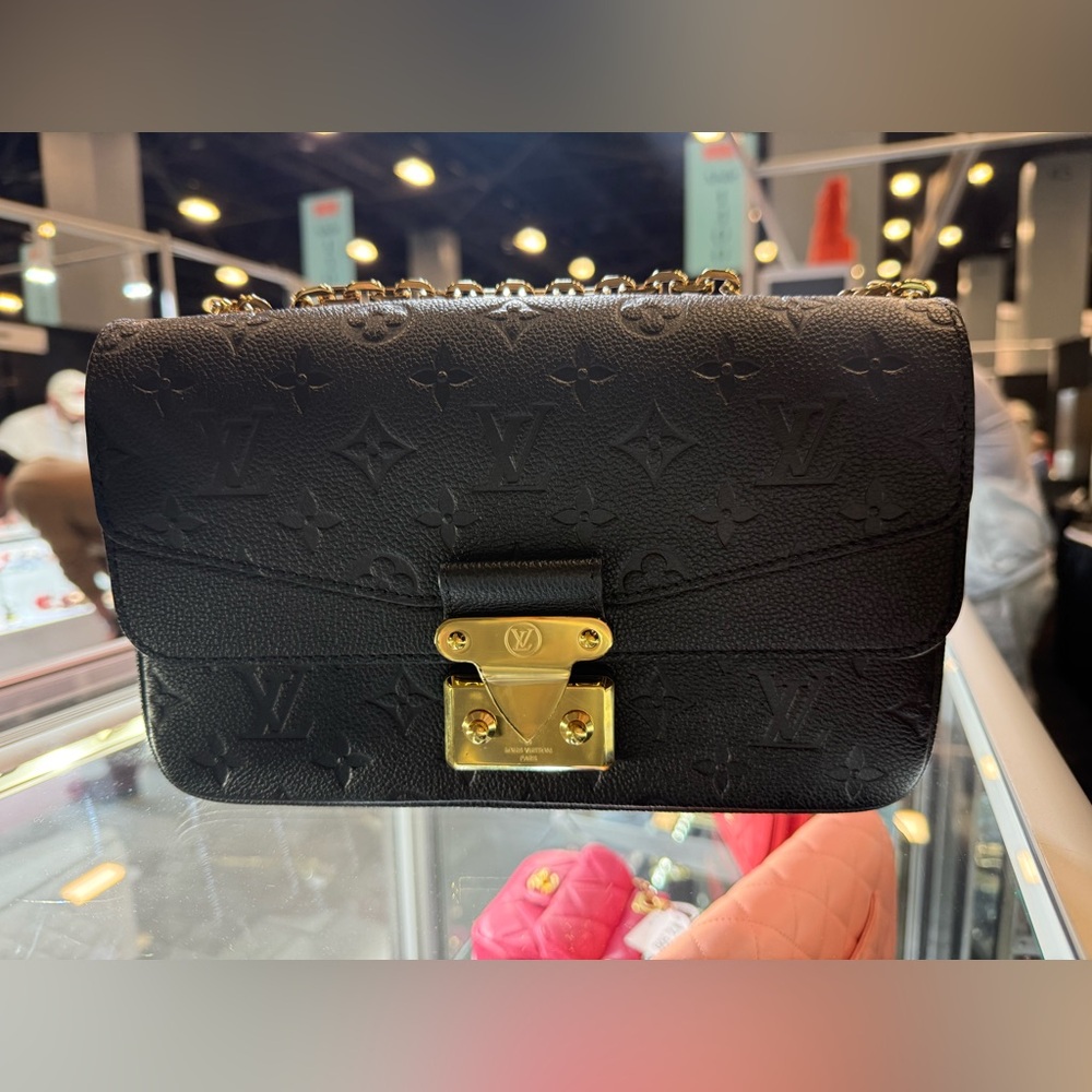 The elegant Marceau chain bag, with its emblematic S-lock and gold-color chain